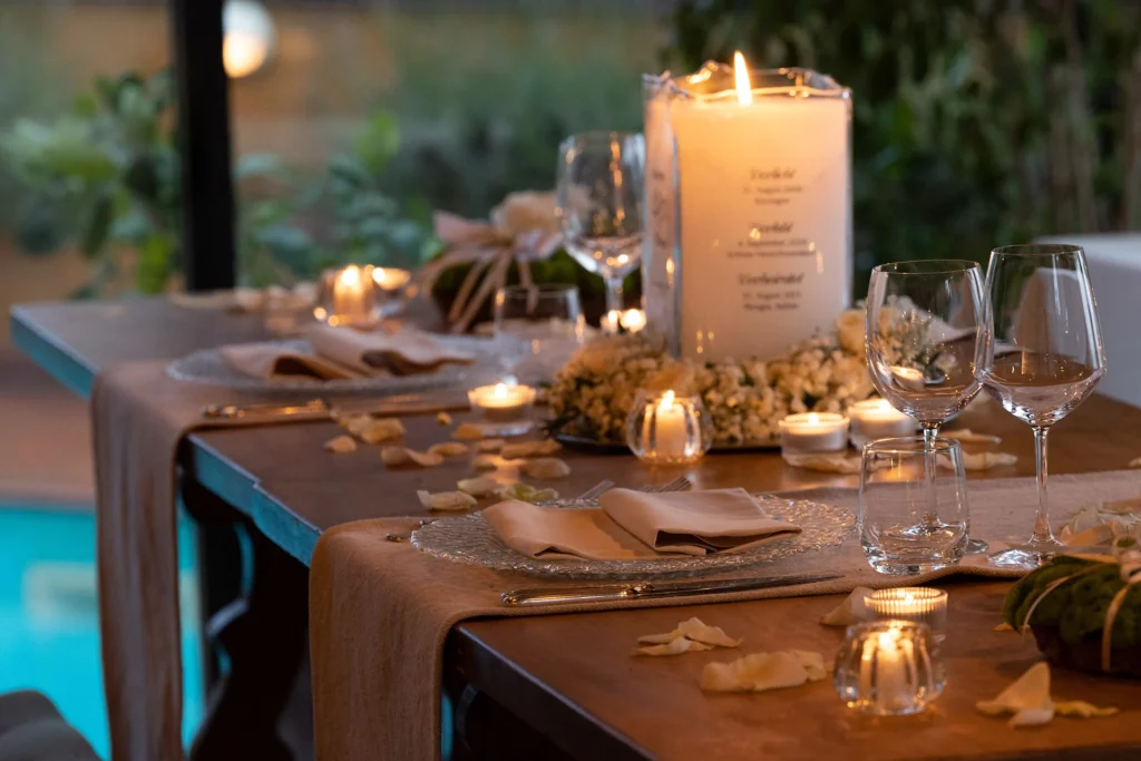 Candlelit reception table with glassware and floral details