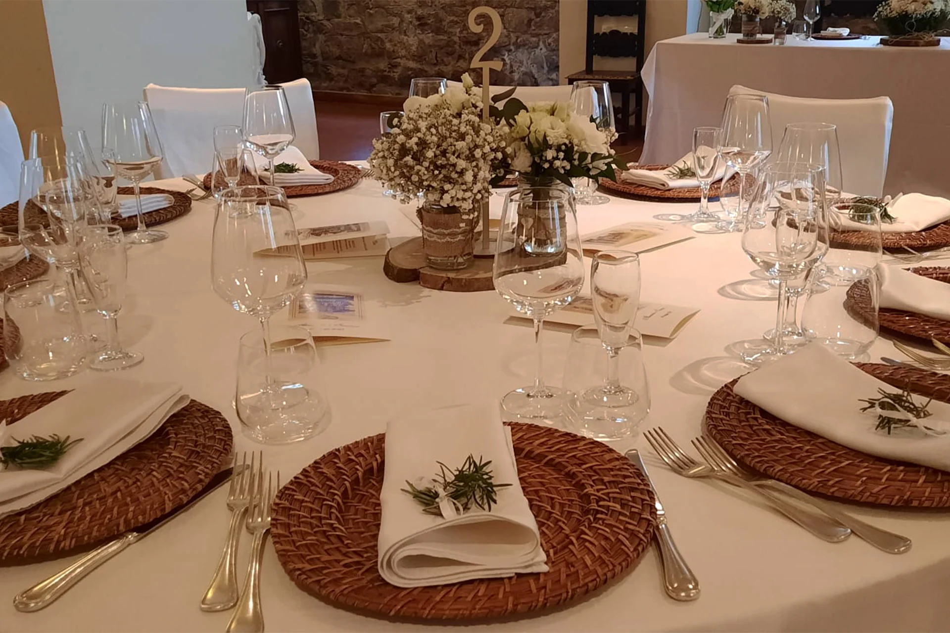 Reception table setting with flowers and glassware indoors
